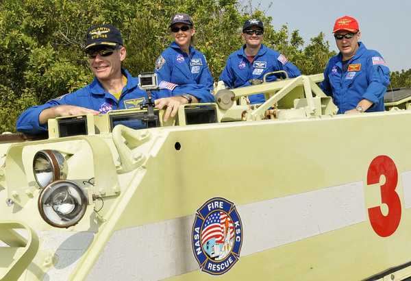 Atlantis crew practices driving their emergency escape vehicle, the M113 APC, on June 21, 2011.